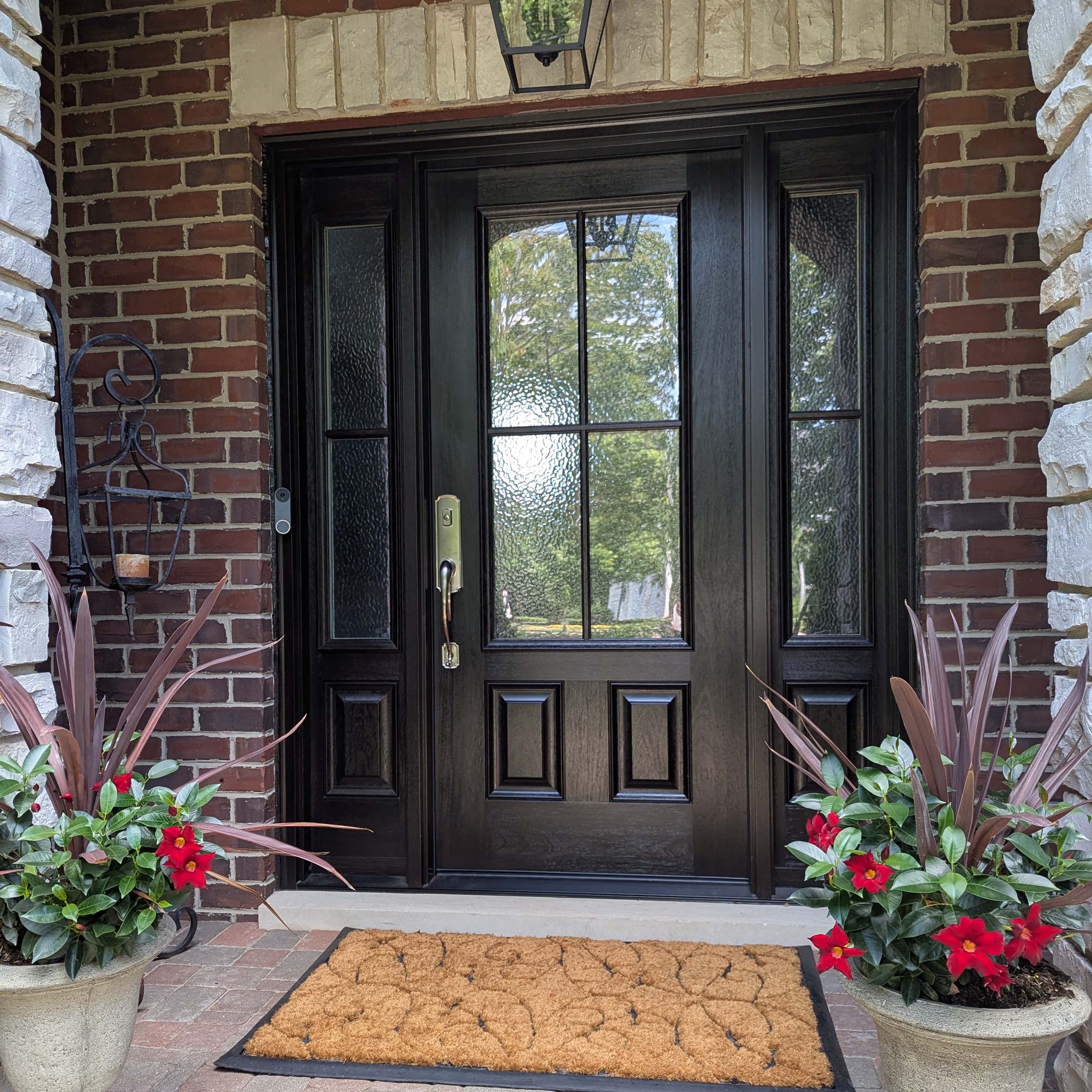 Large residential front door with dark wood stain