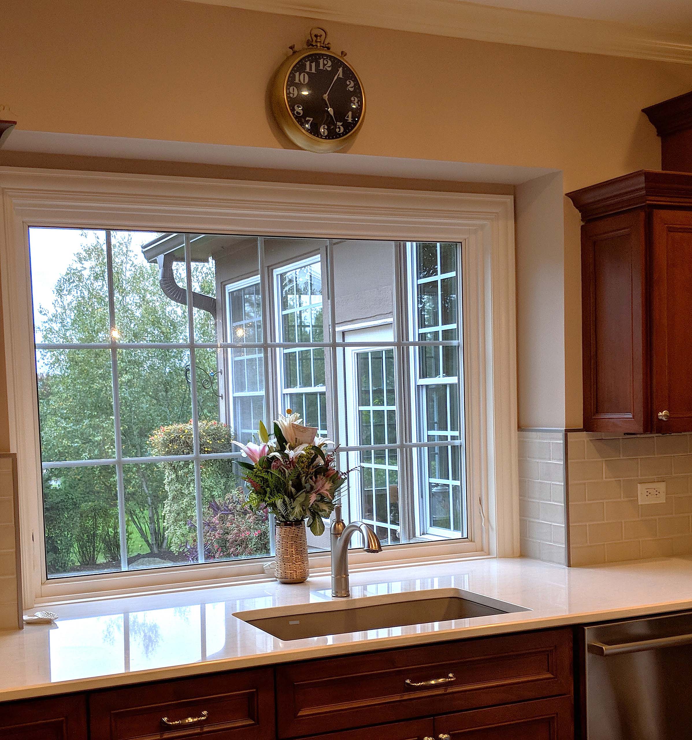 Large window behind kitchen sink with transparent glass